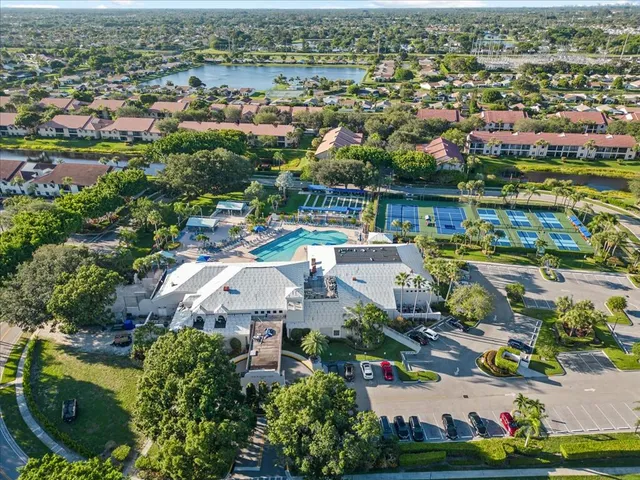 an aerial view of a city with lots of residential buildings ocean and mountain view in back