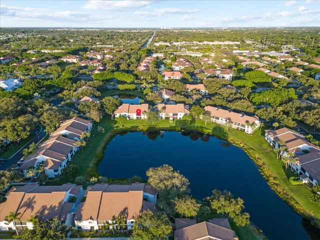 an aerial view of lake and residential houses with outdoor space