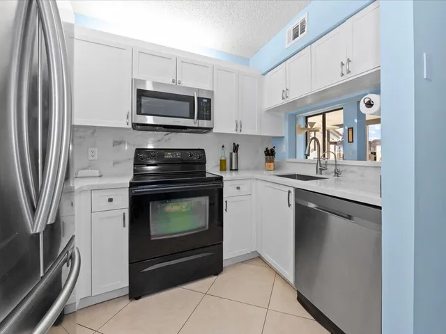 a kitchen with a stove microwave and sink