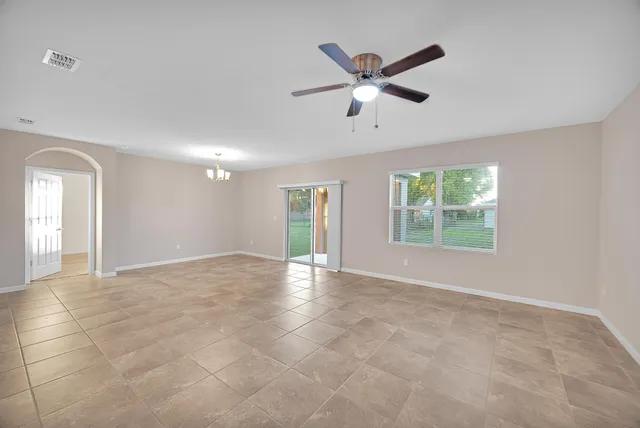 an empty room with a empty space and windows