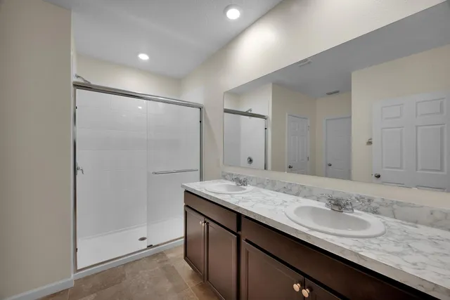 a white toilet sitting next to a white wall