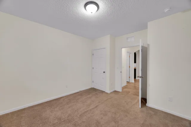 a kitchen with kitchen island granite countertop a sink stove and refrigerator