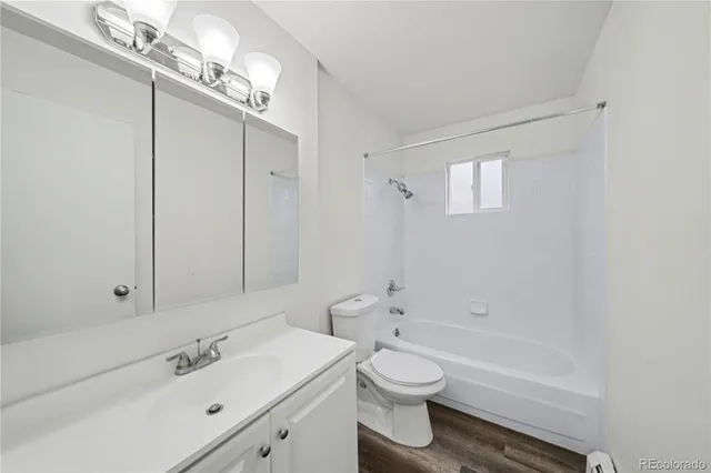 a bathroom with a toilet a sink a mirror and bathtub