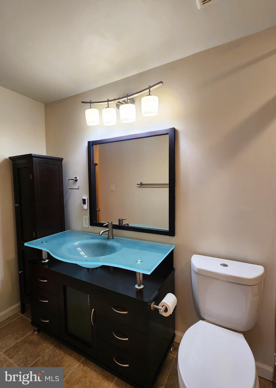 9533 Quarry Bridge Court Columbia, MD 21046 - Photo 12 of 17 a bathroom with a toilet sink and mirror
