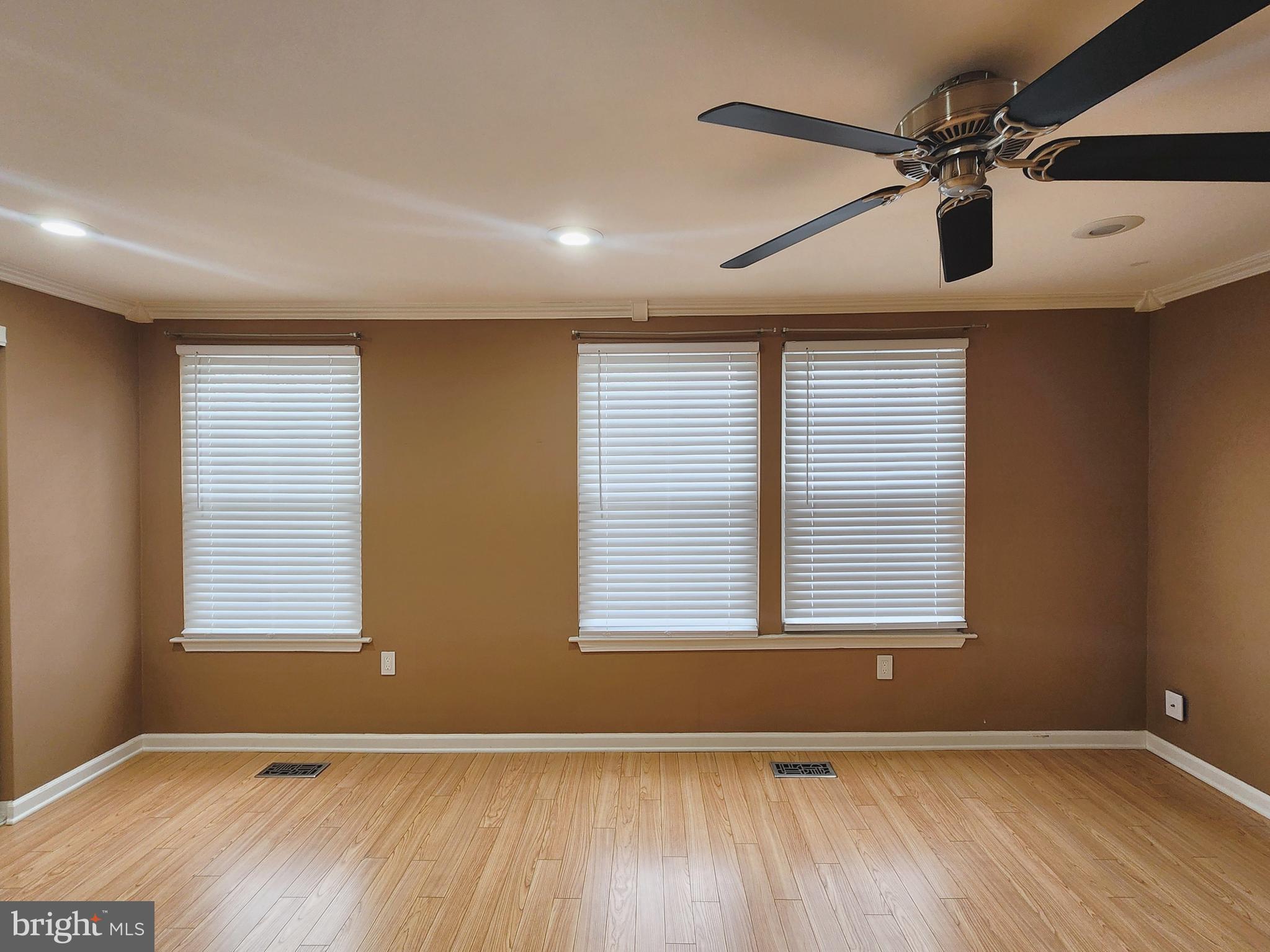 9533 Quarry Bridge Court Columbia, MD 21046 - Photo 16 of 17 wooden floor in an empty room with a window