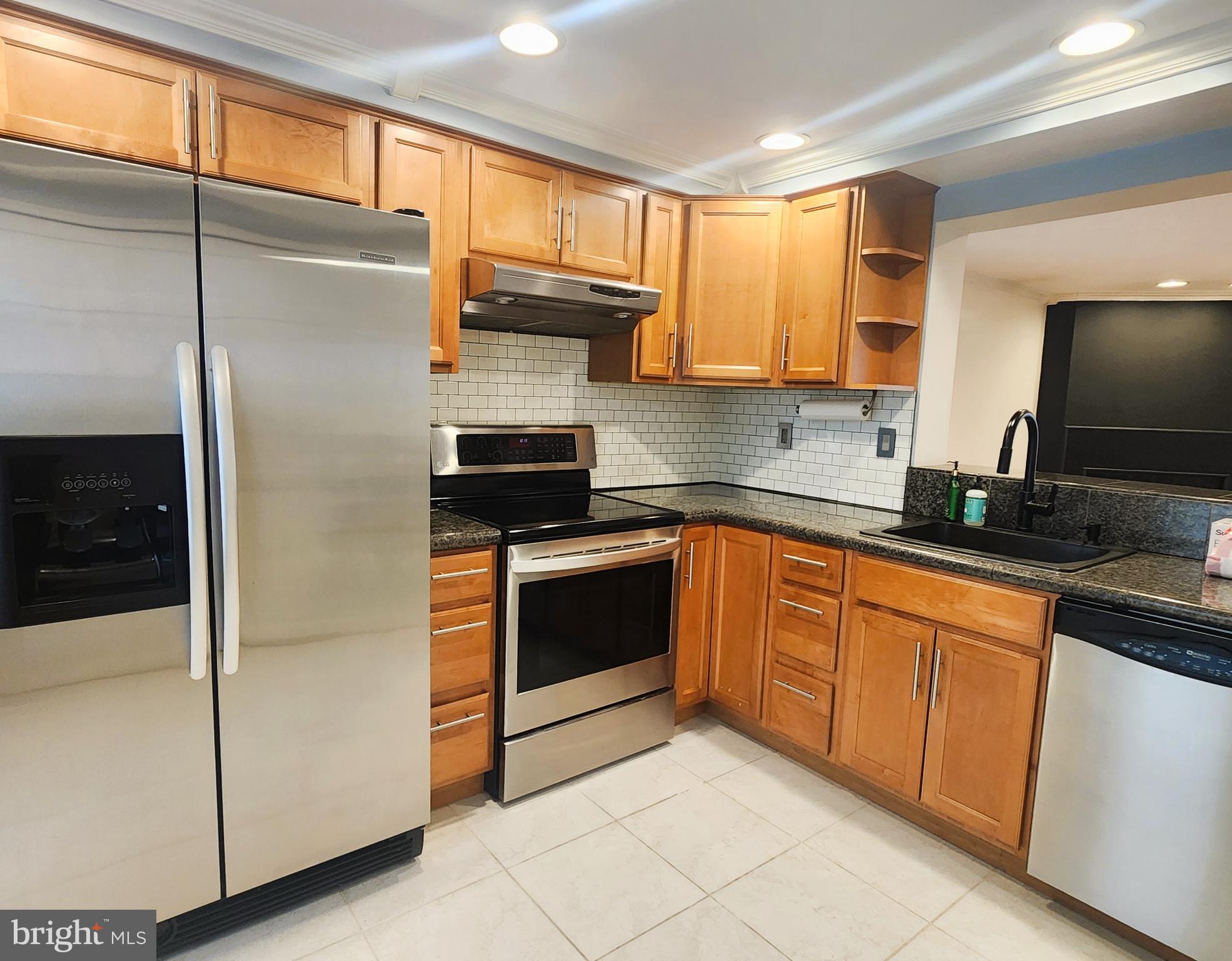 9533 Quarry Bridge Court Columbia, MD 21046 - Photo 7 of 17 a kitchen with stainless steel appliances a refrigerator sink and microwave
