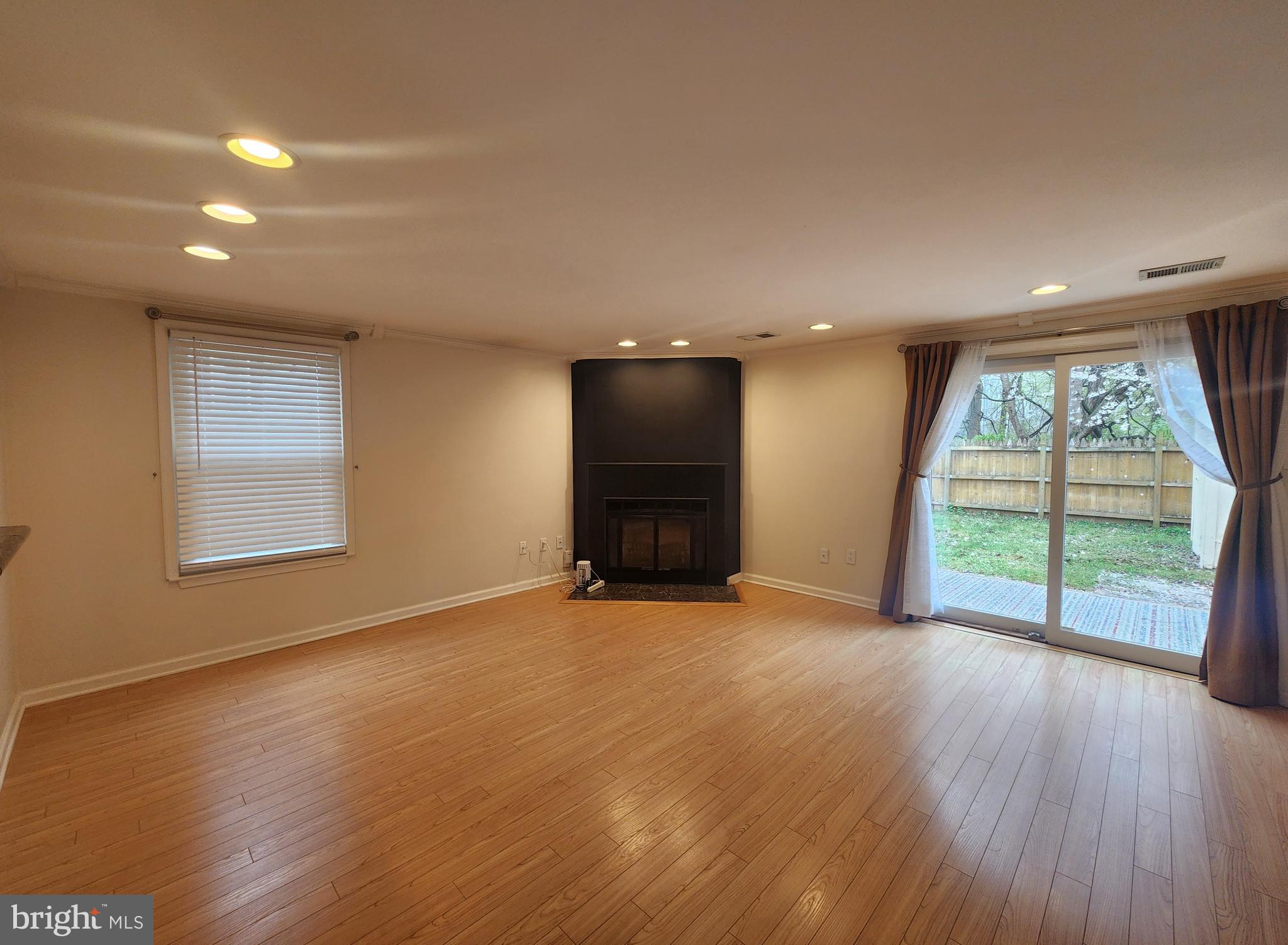 9533 Quarry Bridge Court Columbia, MD 21046 - Photo 9 of 17 an empty room with wooden floor and windows