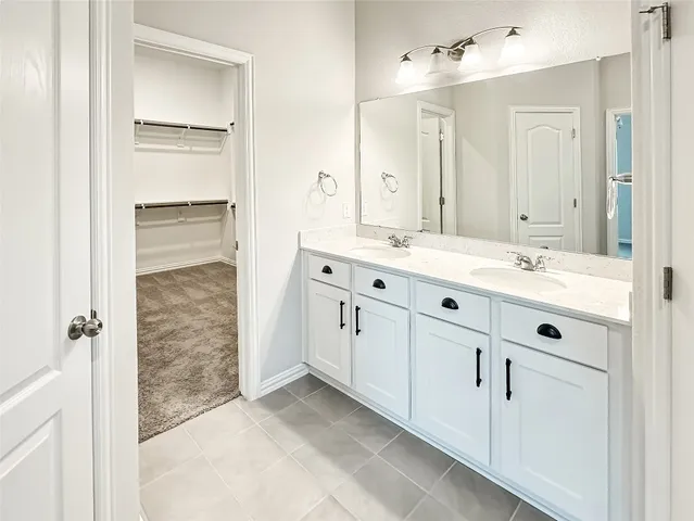 a spacious bathroom with a double vanity sink mirror and