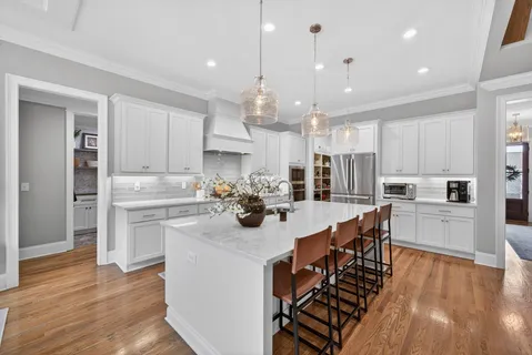 a kitchen with stainless steel appliances granite countertop a sink stove and microwave