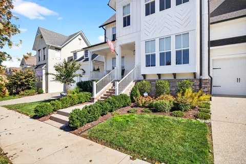 a view of a hallway with wooden floor and stairs