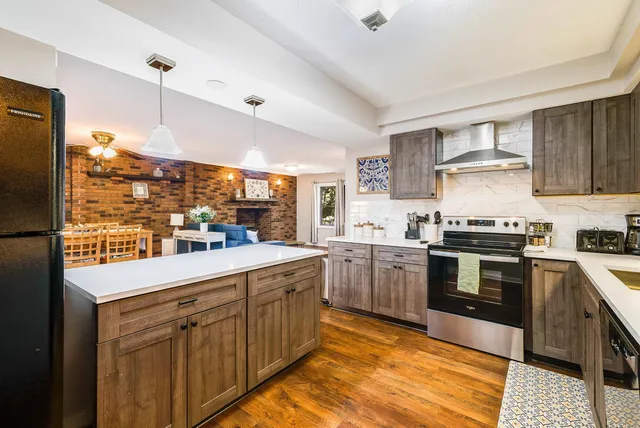 a kitchen with a sink stove and refrigerator