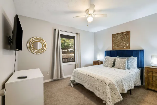 a bedroom with a bed and a chandelier
