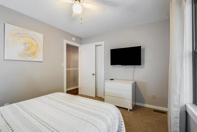 a bedroom with a bed and a flat screen tv