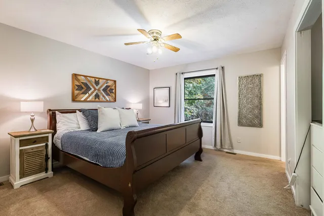 a bedroom with a bed and a chandelier