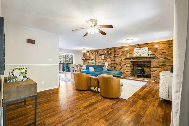 a living room with fireplace furniture and a flat screen tv