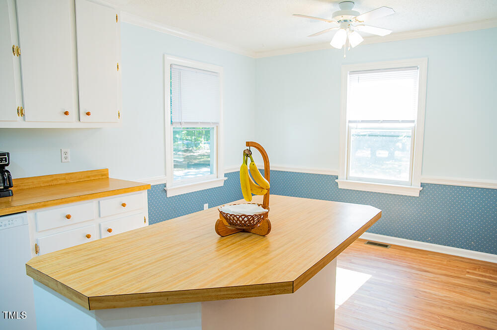 850 Lewis Winstead Lp Road Roxboro, NC 27574 - Photo 13 of 72 a kitchen with a sink a window and wooden floor