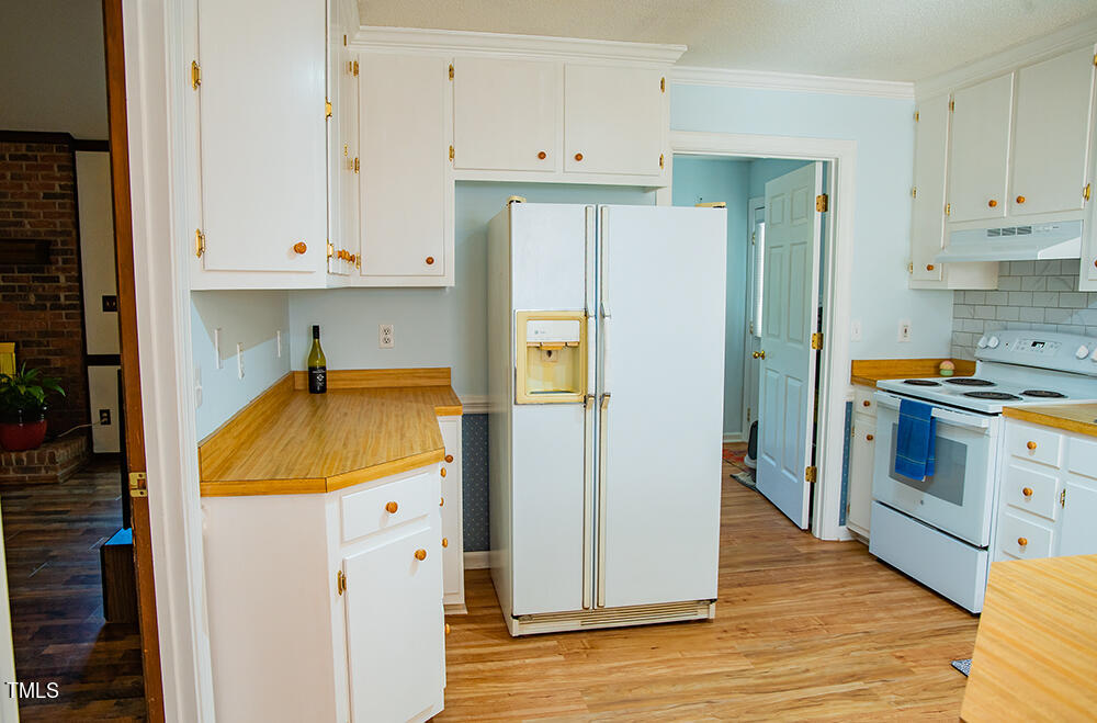 850 Lewis Winstead Lp Road Roxboro, NC 27574 - Photo 21 of 72 a kitchen with stainless steel appliances a refrigerator and a stove