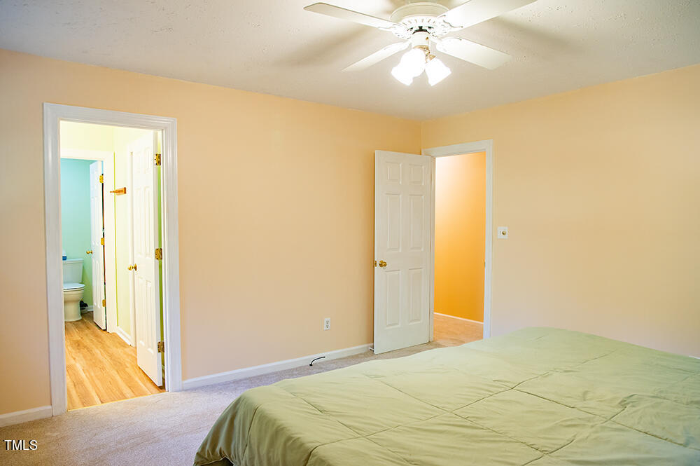 850 Lewis Winstead Lp Road Roxboro, NC 27574 - Photo 26 of 72 a bedroom with a bed and a chandelier
