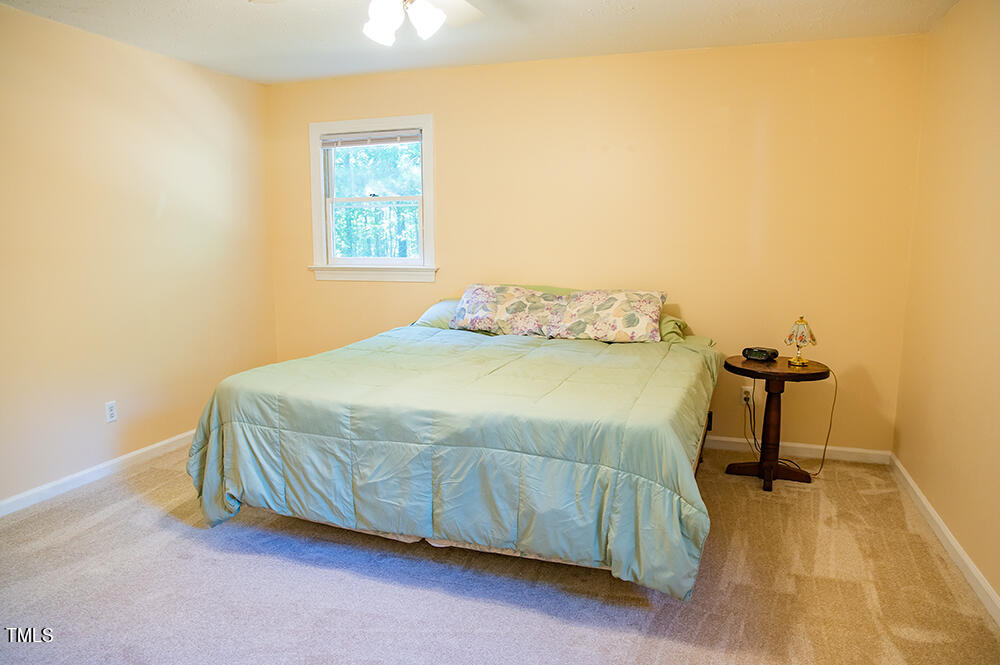 850 Lewis Winstead Lp Road Roxboro, NC 27574 - Photo 27 of 72 a bedroom with a bed and a table in it