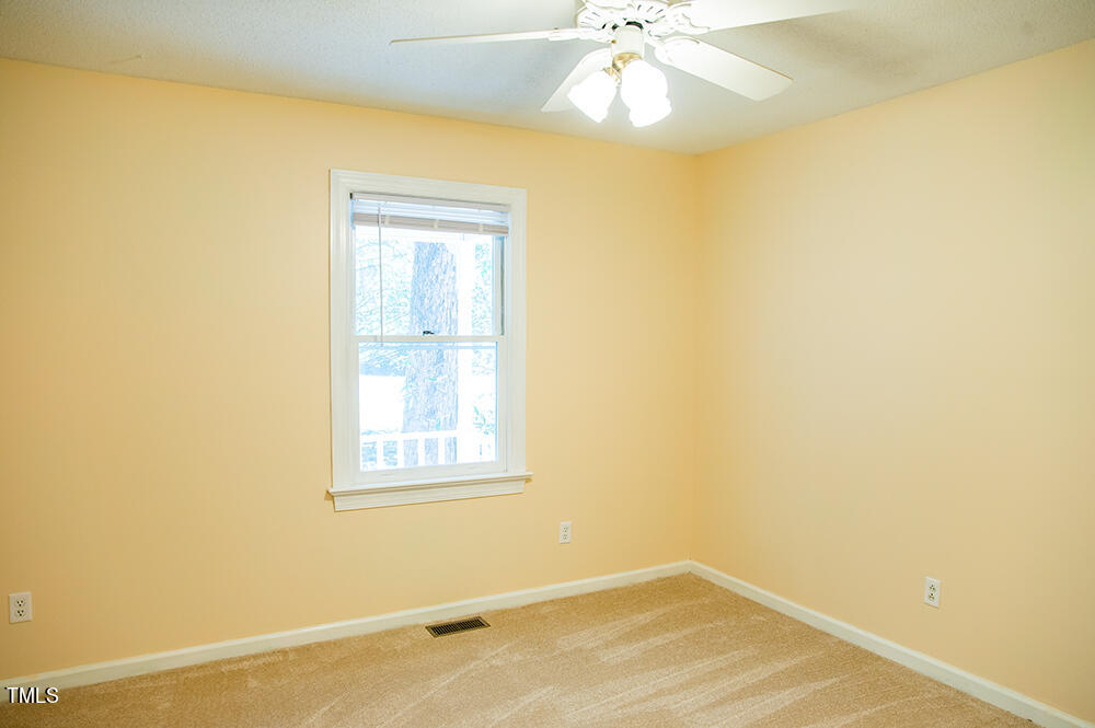 850 Lewis Winstead Lp Road Roxboro, NC 27574 - Photo 37 of 72 an empty room with a window and chandelier fan