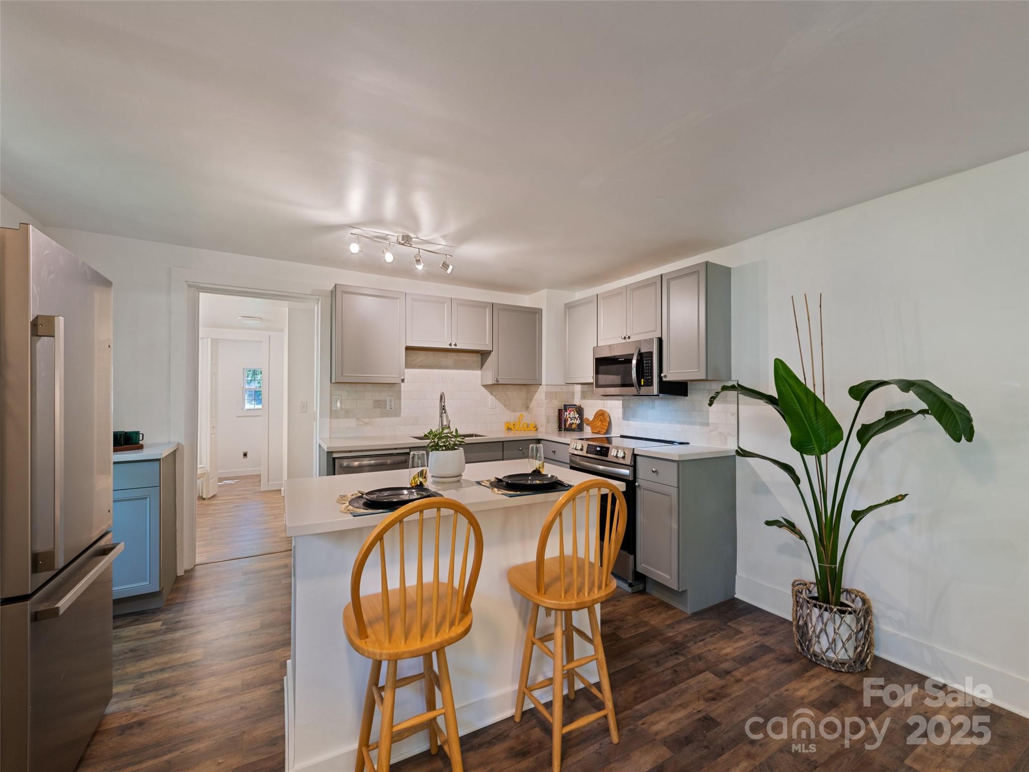 468 Deaverview Road Asheville, NC 28806 - Photo 12 of 26 a dining room with furniture a potted plant and kitchen view