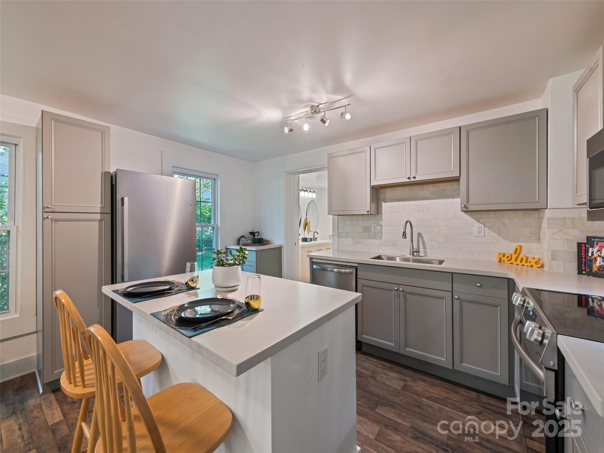 468 Deaverview Road Asheville, NC 28806 - Photo 13 of 26 a kitchen with a dining table chairs appliances a sink and cabinets
