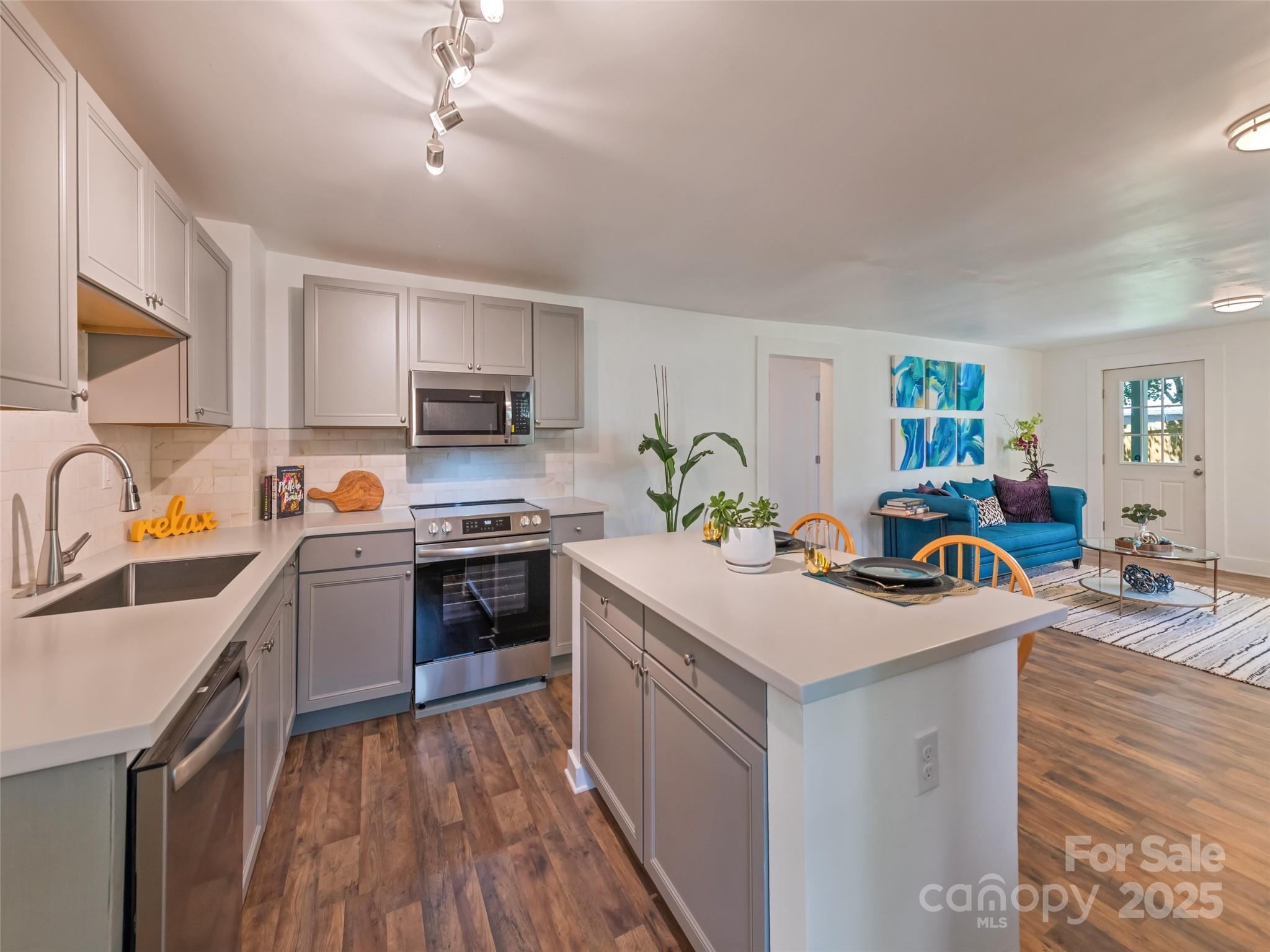 468 Deaverview Road Asheville, NC 28806 - Photo 14 of 26 a kitchen with a stove a sink and a refrigerator