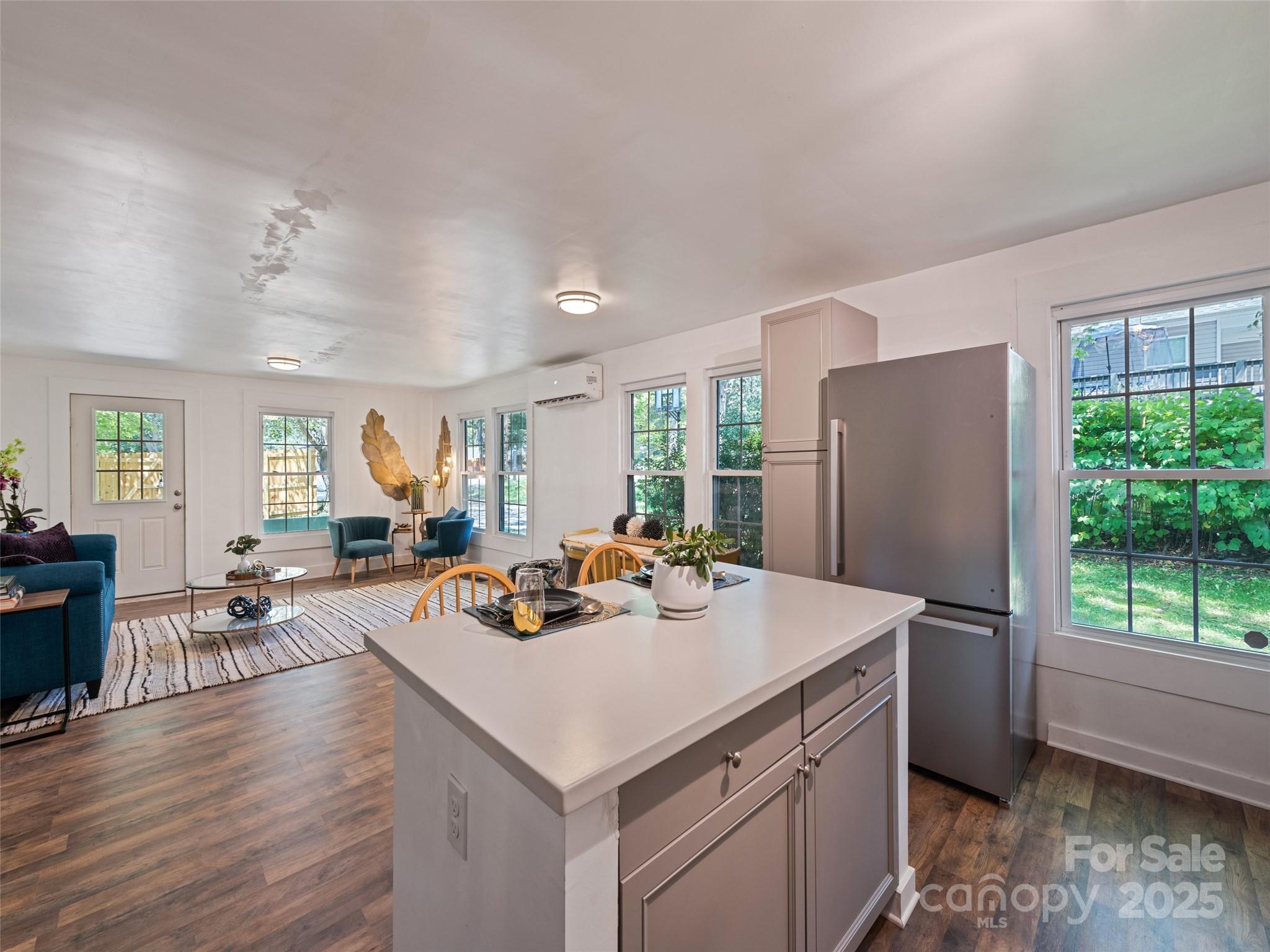 468 Deaverview Road Asheville, NC 28806 - Photo 15 of 26 a kitchen with a refrigerator a stove a dining table and chairs next to a window