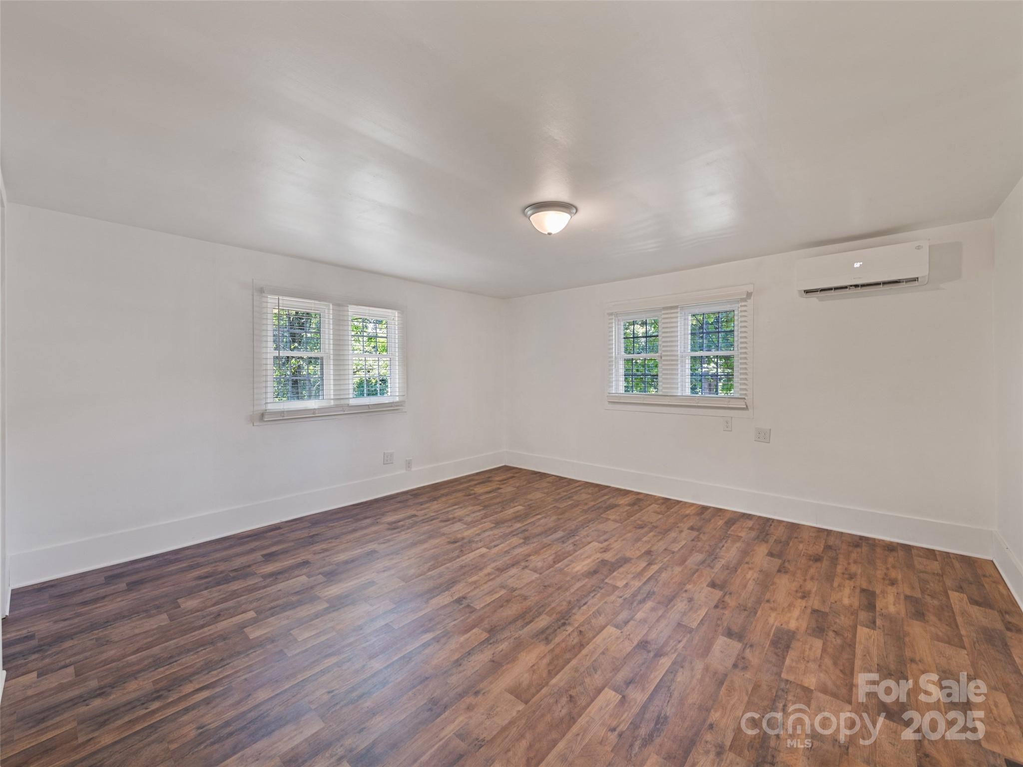 468 Deaverview Road Asheville, NC 28806 - Photo 16 of 26 a view of an empty room with wooden floor and a window