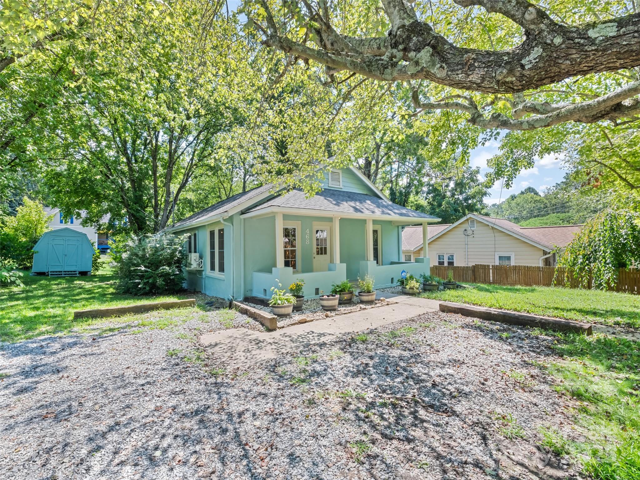 468 Deaverview Road Asheville, NC 28806 - Photo 2 of 26 a front view of a house with a yard and garage
