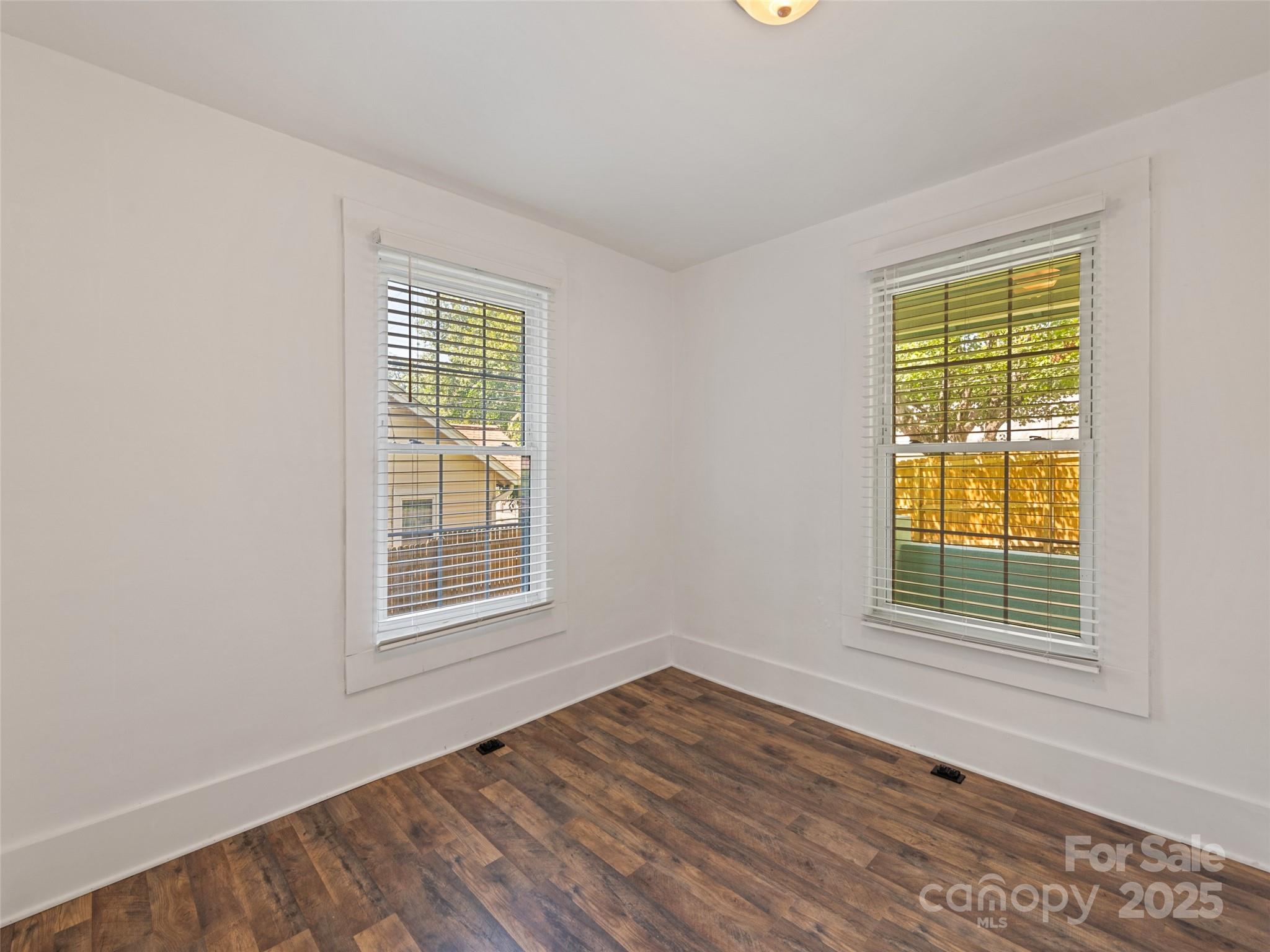 468 Deaverview Road Asheville, NC 28806 - Photo 25 of 26 a view of an empty room with wooden floor and a window