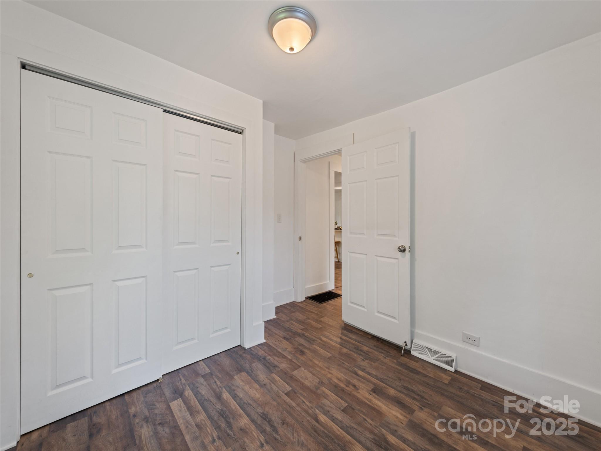 468 Deaverview Road Asheville, NC 28806 - Photo 26 of 26 an empty room with wooden floor and closet