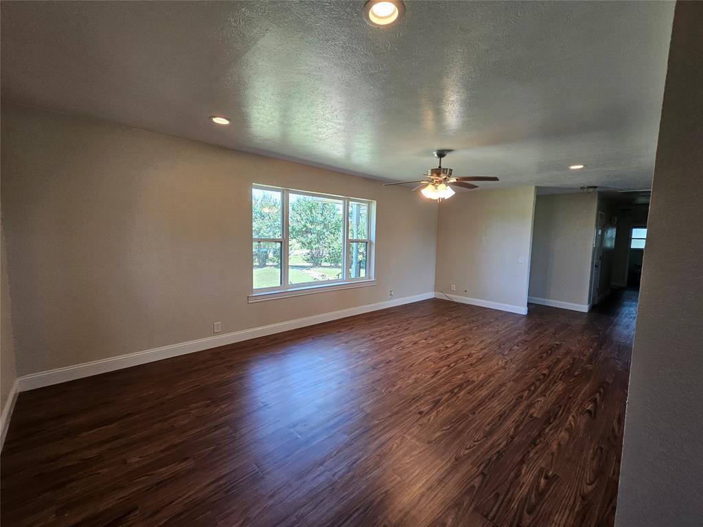 2100 Farm To Market 4 Cleburne, TX 76031 - Photo 11 of 16 an empty room with wooden floor and windows