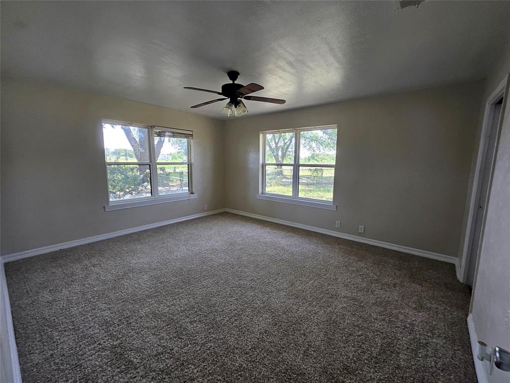 2100 Farm To Market 4 Cleburne, TX 76031 - Photo 3 of 16 an empty room with windows and ceiling fan view