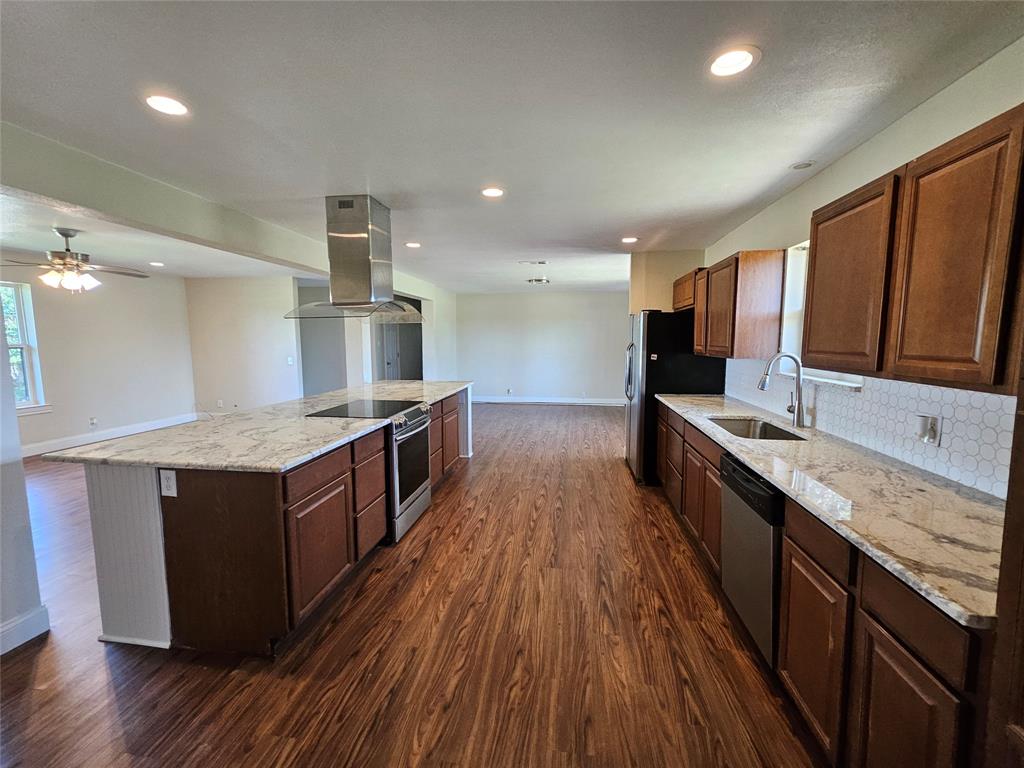 2100 Farm To Market 4 Cleburne, TX 76031 - Photo 14 of 16 a kitchen with stainless steel appliances granite countertop wooden cabinets and a granite counter tops