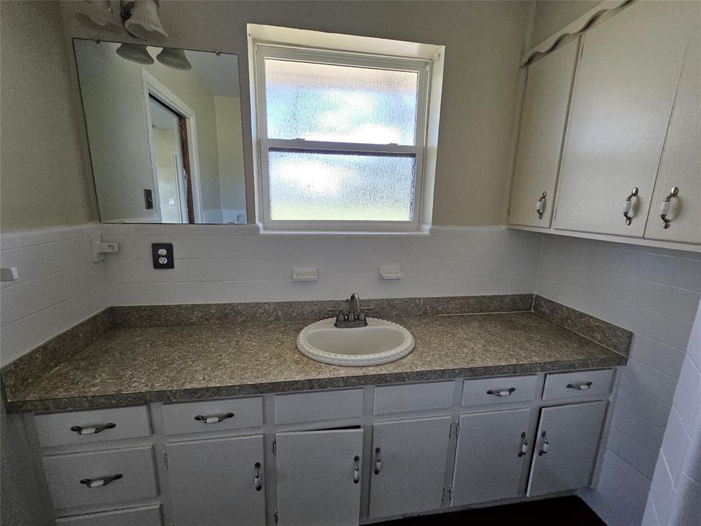 2100 Farm To Market 4 Cleburne, TX 76031 - Photo 8 of 16 a bathroom with a granite countertop sink and a mirror