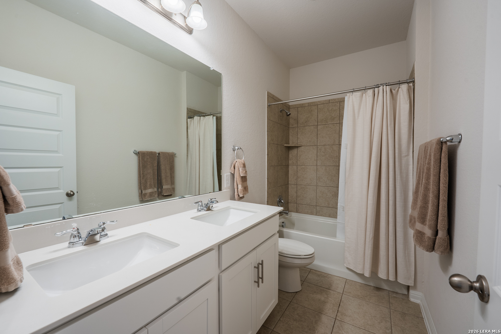 4947 Ranahan Pass St. Hedwig, TX 78152 - Photo 26 of 37 a bathroom with a double vanity sink toilet and shower