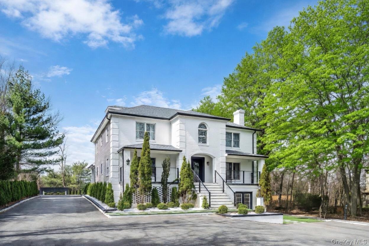 68 Fort Salonga Road Northport, NY 11768 - Photo 2 of 50 a front view of a house with a garden