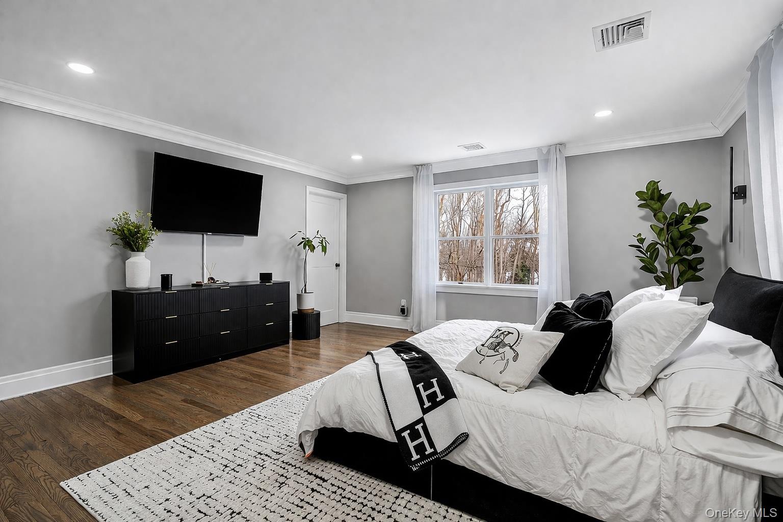 68 Fort Salonga Road Northport, NY 11768 - Photo 26 of 50 a bedroom with a bed and a flat screen tv