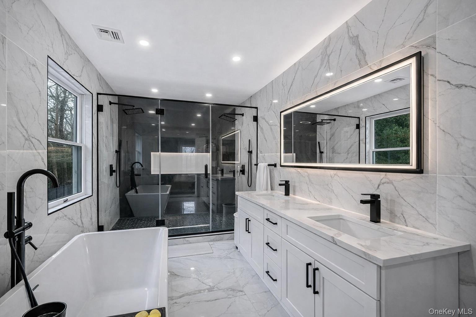 68 Fort Salonga Road Northport, NY 11768 - Photo 28 of 50 a bathroom with a double vanity sink a toilet a mirror and shower