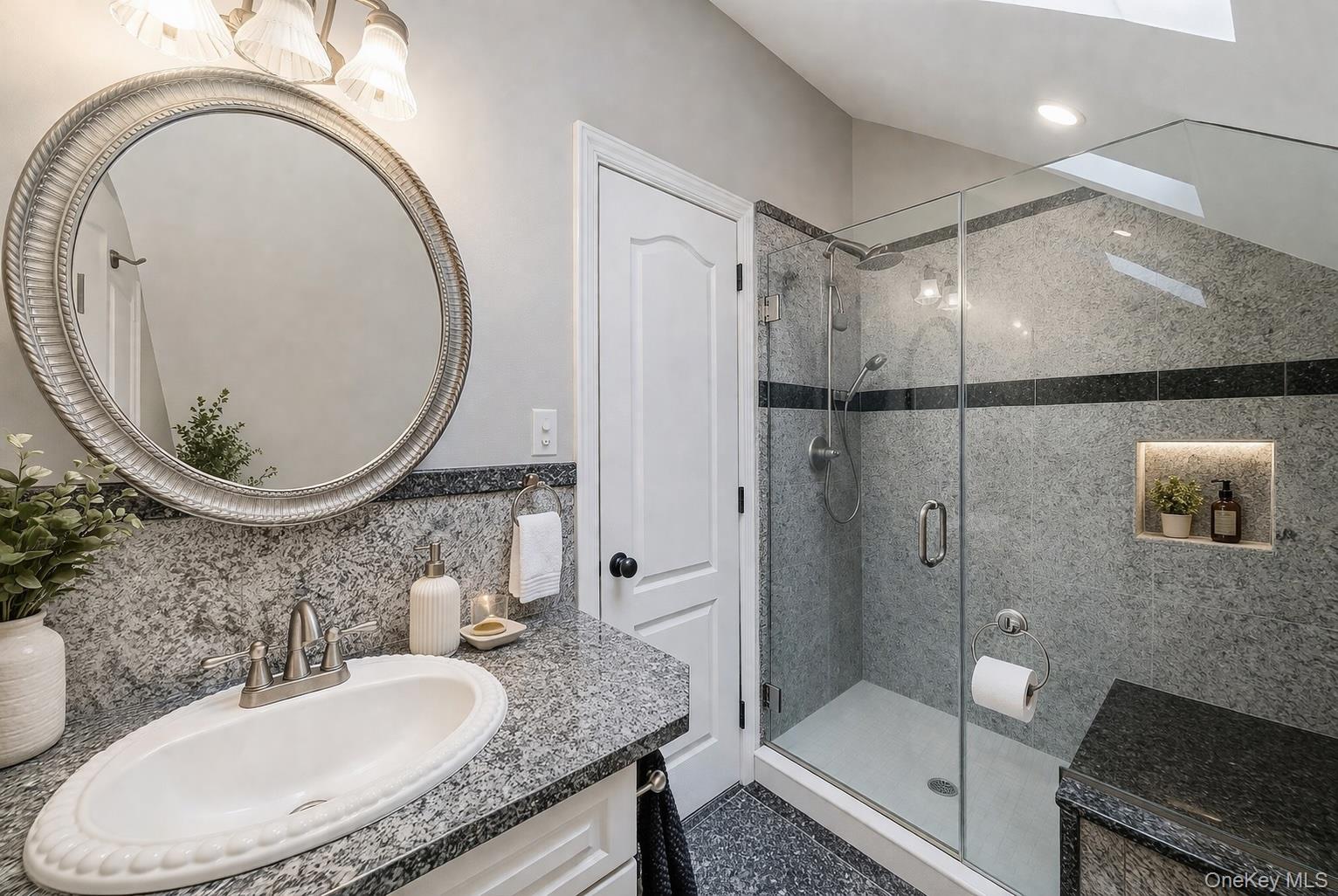 68 Fort Salonga Road Northport, NY 11768 - Photo 35 of 50 a bathroom with a granite countertop bathtub a sink and a mirror