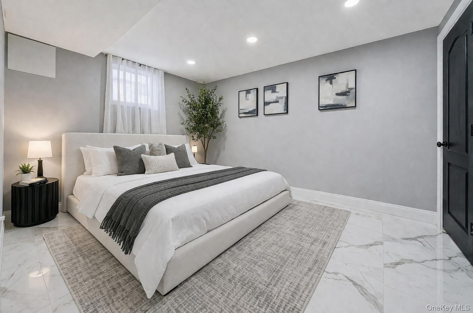 68 Fort Salonga Road Northport, NY 11768 - Photo 41 of 50 a bedroom with a large bed and a chandelier