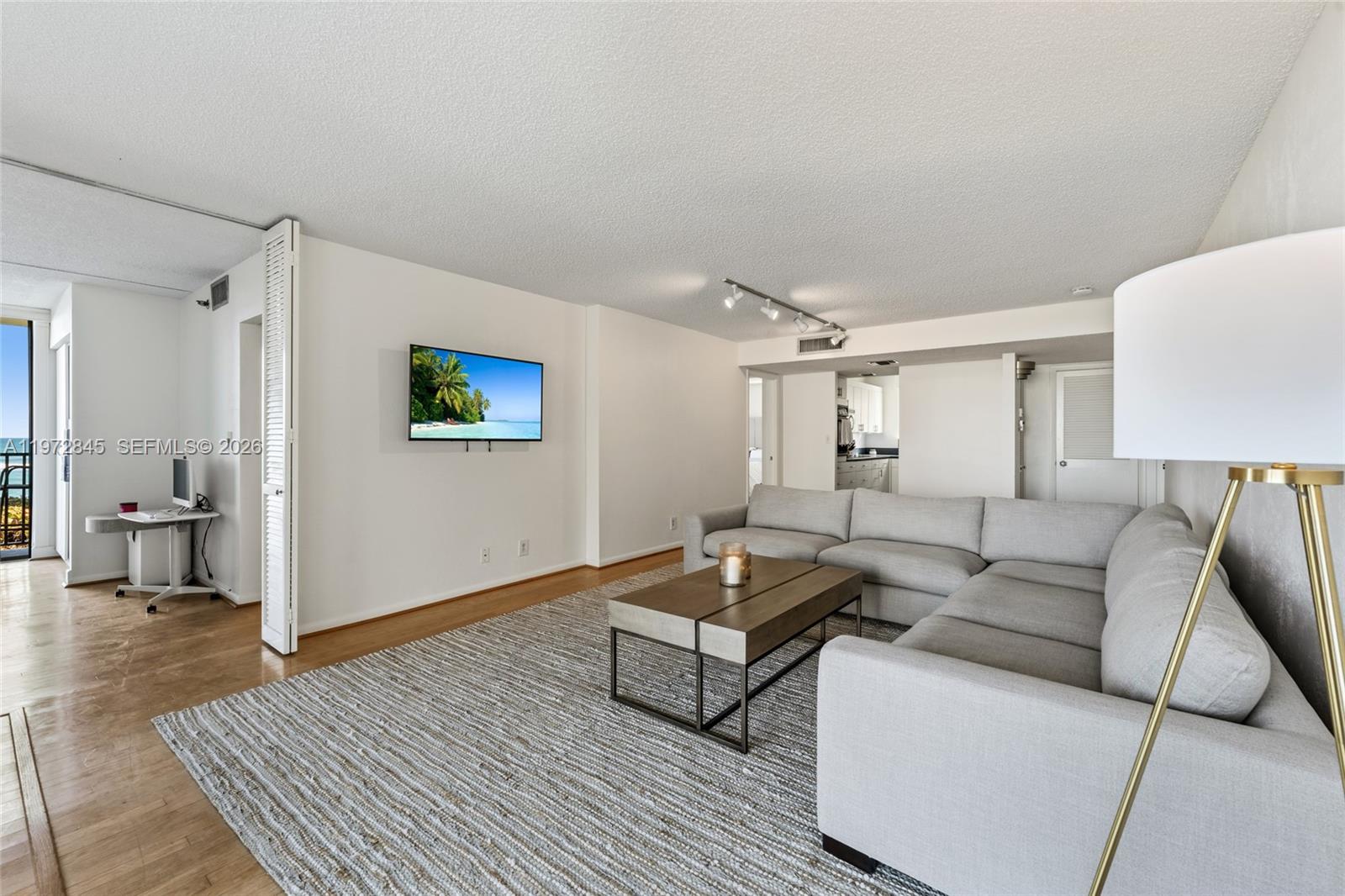 300 Ocean Trail Way, Unit 201 Jupiter, FL 33477 - Photo 4 of 15 a living room with furniture and a wooden floor