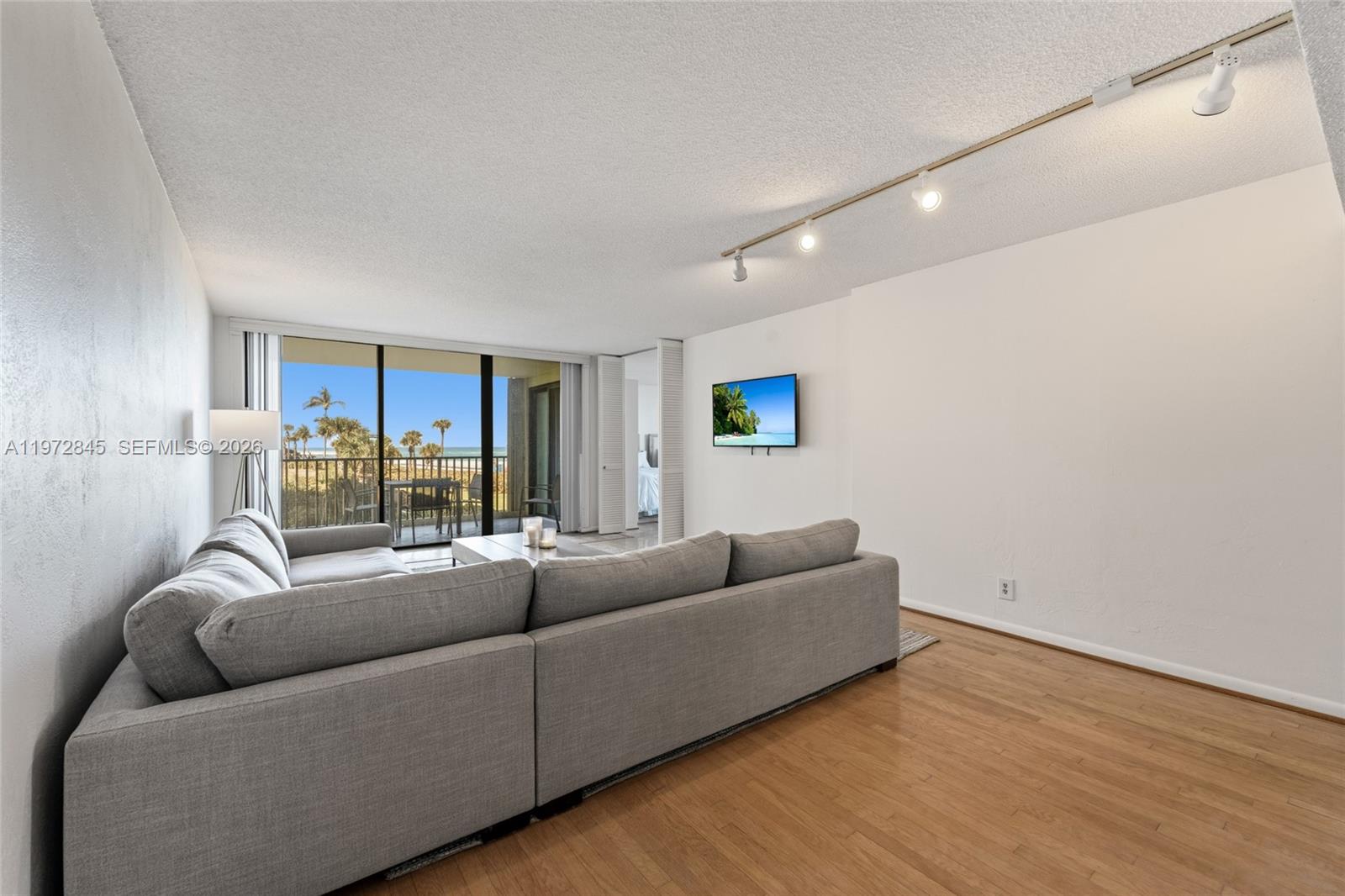 300 Ocean Trail Way, Unit 201 Jupiter, FL 33477 - Photo 5 of 15 a living room with furniture and a large window