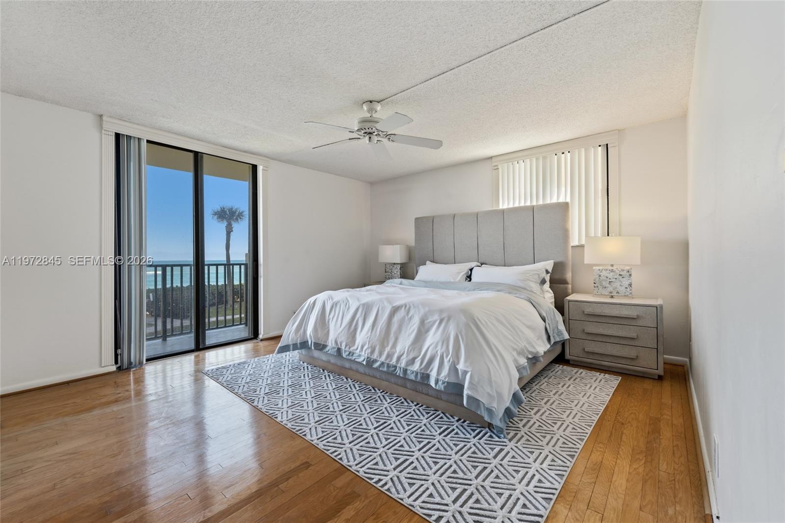 300 Ocean Trail Way, Unit 201 Jupiter, FL 33477 - Photo 7 of 15 a bedroom with a large bed and a chandelier