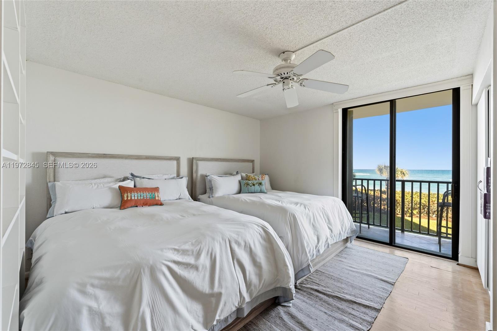 300 Ocean Trail Way, Unit 201 Jupiter, FL 33477 - Photo 8 of 15 a bedroom with a large bed and a chandelier