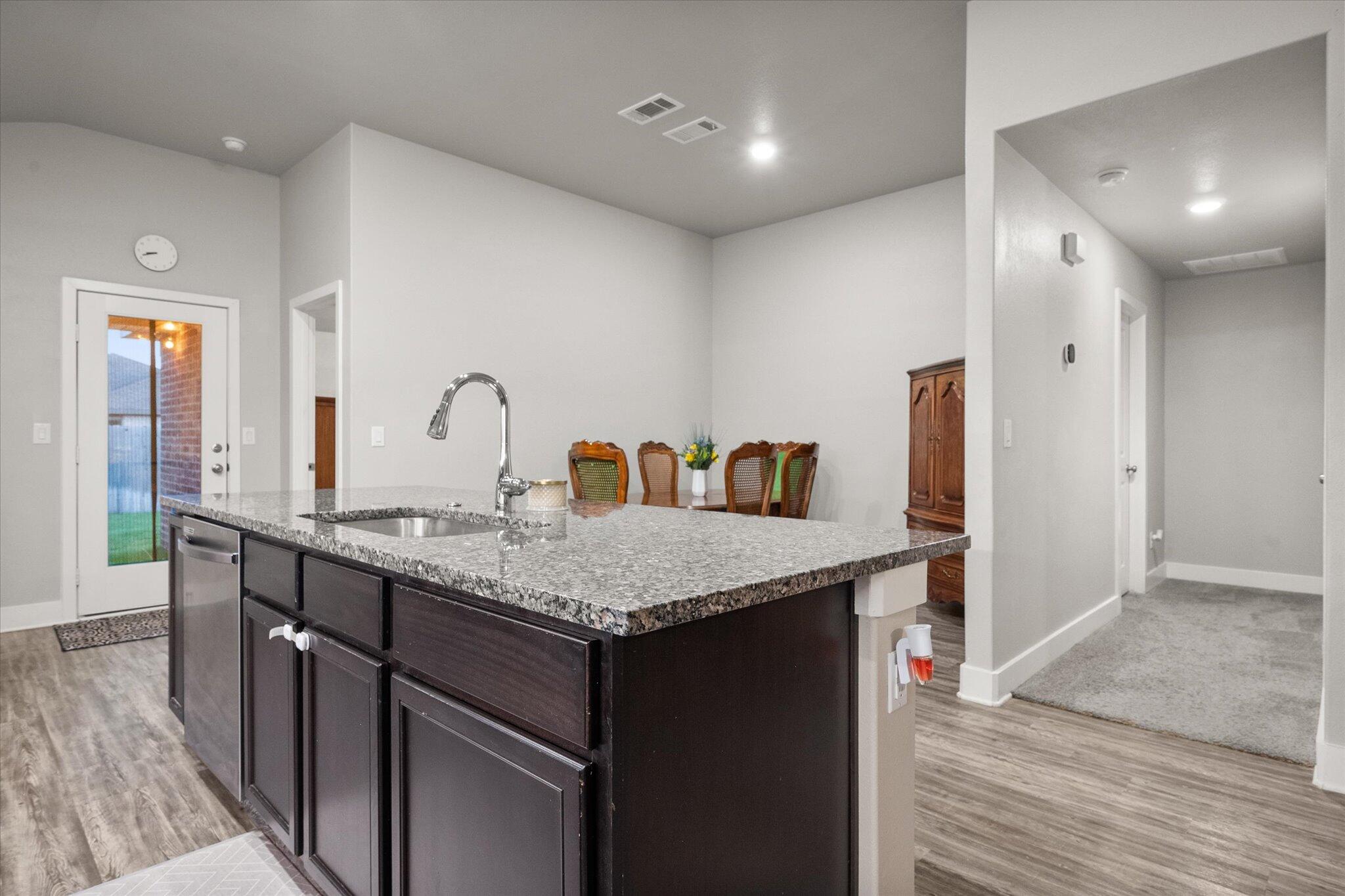 7449 31st Street Lubbock, TX 79407 - Photo 11 of 23 a kitchen with stainless steel appliances granite countertop a sink and a refrigerator