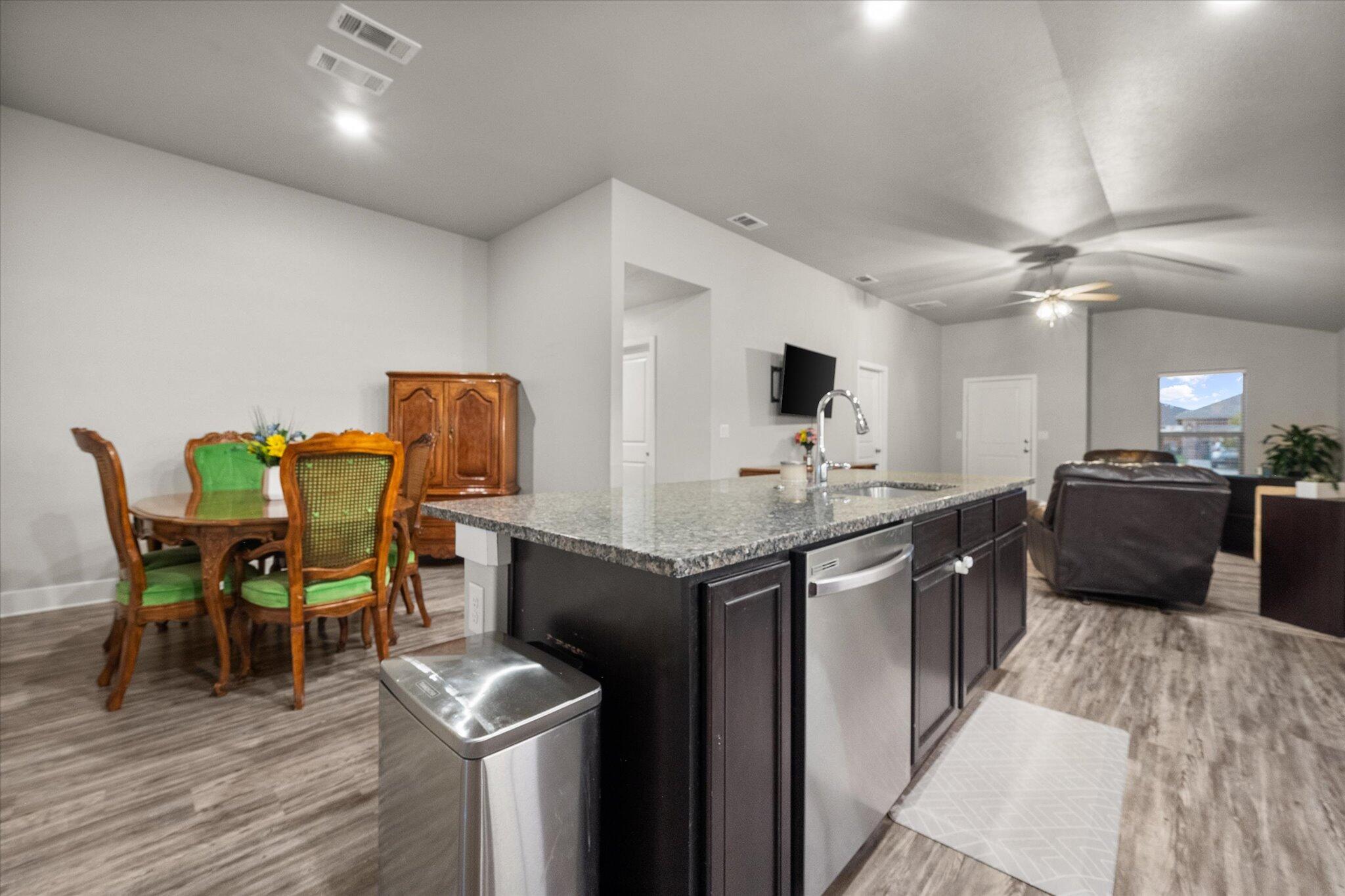 7449 31st Street Lubbock, TX 79407 - Photo 12 of 23 a kitchen with a table chairs microwave and cabinets