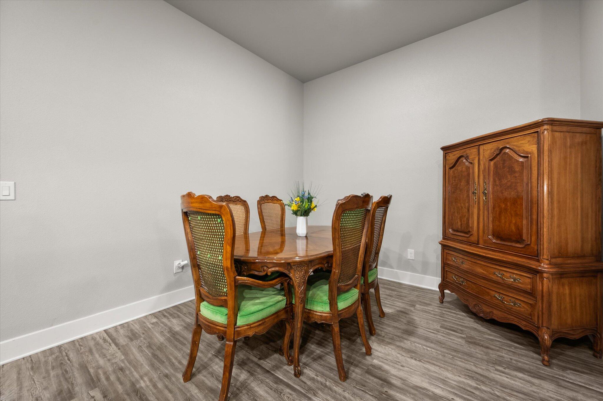 7449 31st Street Lubbock, TX 79407 - Photo 13 of 23 a view of a dining room with furniture and wooden floor