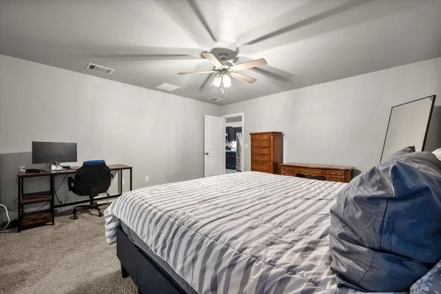 a bedroom with a bed and a chandelier